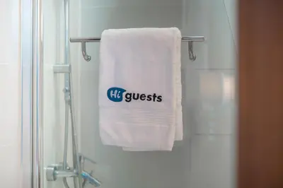 a bathroom with a towel with his guess on it at HiGuests - Spacious 1BR in Dubai Marina With Amazing Views in Dubai
