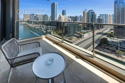 a balcony with a white table and a view of a city at Sparkle Tower, Dubai Marina in Dubai