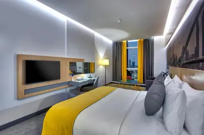 a hotel room with a large bed and a television at URBAN Al Khoory Hotel in Dubai