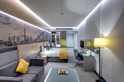 a hotel room with a bed and a couch at URBAN Al Khoory Hotel in Dubai