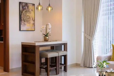 a small table with stools in a living room at Westminster Boulevard Point in Dubai