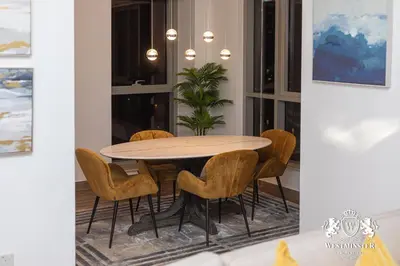 a dining room with a round table and chairs at Westminster Boulevard Central - Burj Khalifa in Dubai
