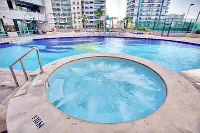 a large swimming pool in a building at The Waves by DAMAC, Dubai Marina in Dubai