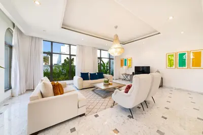 a living room with white furniture and large windows at Maison Privee - Luxury Villa with Dramatic View Private Beach & Pool in Dubai