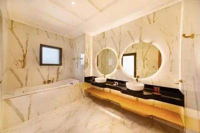 a bathroom with two sinks and two mirrors at Maison Privee - Luxury Villa with Dramatic View Private Beach & Pool in Dubai