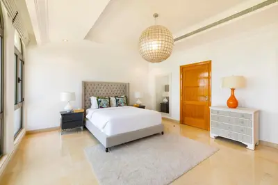 a white bedroom with a bed and a rug at Maison Privee - Luxury Villa with Dramatic View Private Beach & Pool in Dubai