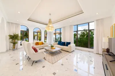 a living room with white furniture and large windows at Maison Privee - Luxury Villa with Dramatic View Private Beach & Pool in Dubai