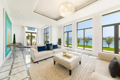 a living room with white furniture and large windows at Maison Privee - Luxury Villa with Dramatic View Private Beach & Pool in Dubai
