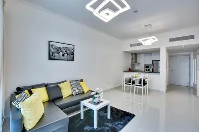 a living room with a couch and a table at Ultra modern 1BD in Damac Heights Marina in Dubai