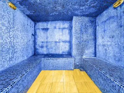 an empty room with blue tile walls and wooden floors at Ultra modern 1BD in Damac Heights Marina in Dubai