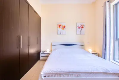 a bedroom with a bed and two paintings on the wall at Bay Central 1BD apartment with awesome Marina view in Dubai
