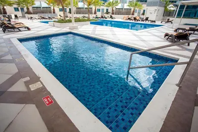 a swimming pool with blue water in a building at Bay Central 1BD apartment with awesome Marina view in Dubai