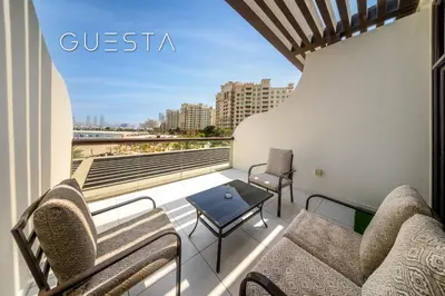 a balcony with chairs and a view of the beach at Club Vista Mare, free Riva beach club access in Dubai