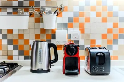 a kitchen counter with a coffee maker and a toaster at Club Vista Mare, free Riva beach club access in Dubai