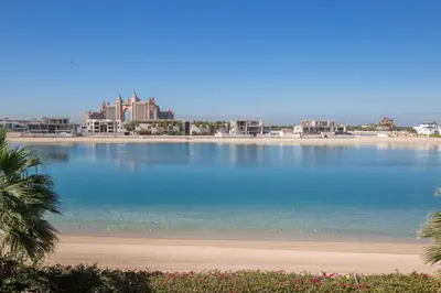 a view of a beach with buildings in the background at Maison Privee - Prvt Pool & Beach Access in Luxury Palm Jumeirah 6BR Villa in Dubai
