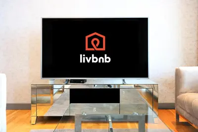 a flat screen tv sitting on top of a glass table at Bluewaters Island - High-Floor 1 Bedroom Suite by Livbnb in Dubai