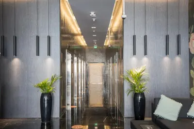 a lobby with two black vases with plants in it at HiGuests - Studio With Incredible Sea Views, 3-min to Beach in Dubai