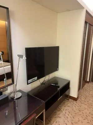 a living room with a television on a wall at Address Dubai Mall Fashion Avenue 1 bedroom 34 floor in Dubai