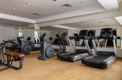 a gym with several treadmills and elliptical machines at Frank Porter - Mon Reve in Dubai