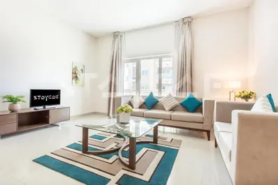 a living room with a couch and a table at Staycae Holiday Homes - Suburbia in Dubai