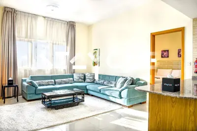 a living room with a blue couch and a table at Staycae Holiday Homes - Suburbia in Dubai