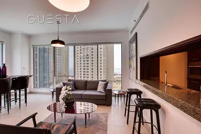 a living room with a couch and a table at Marina Promenade - Paloma Tower, Dubai Marina in Dubai