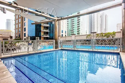 a swimming pool on top of a building at Marina Promenade - Paloma Tower, Dubai Marina in Dubai