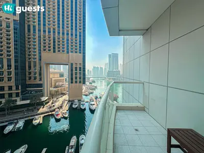 a view of a river in a city with boats at HiGuests - Deluxe Apartment With Balcony and Amazing Views in Dubai