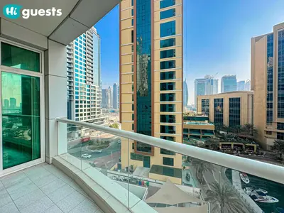 a balcony with a view of a city with tall buildings at HiGuests - Deluxe Apartment With Balcony and Amazing Views in Dubai