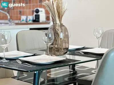 a black table with glasses and a vase on it at HiGuests - Deluxe Apartment With Balcony and Amazing Views in Dubai