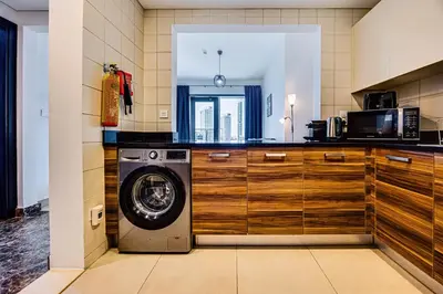 a kitchen with a washing machine in a kitchen at 5 star Sparkle Tower by Swarovski, Dubai Marina in Dubai