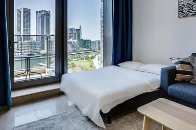 a bedroom with a bed and a large window at 5 star Sparkle Tower by Swarovski, Dubai Marina in Dubai