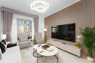 a living room with a large flat screen tv at Maison Privee - Exclusive Duplex Villa with Panoramic Terrace Overlooking Burj Khalifa in Dubai