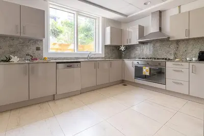 a large kitchen with white cabinets and an oven at Frank Porter - Mon Reve in Dubai