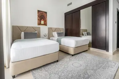 a bedroom with two beds and a mirror at Frank Porter - Mon Reve in Dubai