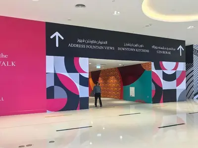 a man standing in front of a exhibit at an art exhibit at Frank Porter - Mon Reve in Dubai