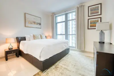 a bedroom with a bed and a desk and a window at Close to Burj Khalifa & Dubai Mall with Relaxing Balcony, Claren Tower 1, Downtown Dubai by Deluxe Holiday Homes in Dubai