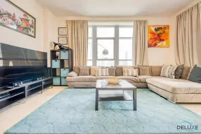 a living room with a couch and a table at Close to Burj Khalifa & Dubai Mall with Relaxing Balcony, Claren Tower 1, Downtown Dubai by Deluxe Holiday Homes in Dubai