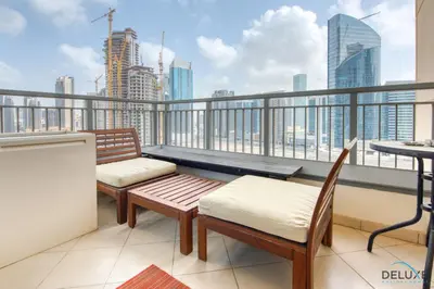 a balcony with two benches and a view of the city at Close to Burj Khalifa & Dubai Mall with Relaxing Balcony, Claren Tower 1, Downtown Dubai by Deluxe Holiday Homes in Dubai