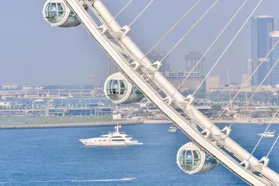 a cruise ship in the water near a city at Contemporary and Spacious 2 BR in Bluewaters Island in Dubai