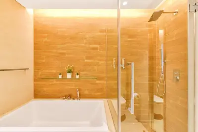 a bathroom with a tub and a glass shower at Contemporary and Spacious 2 BR in Bluewaters Island in Dubai
