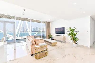 a living room with a couch and a tv at Contemporary and Spacious 2 BR in Bluewaters Island in Dubai