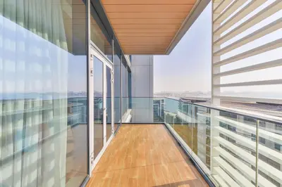 an empty balcony in a building with glass walls at Posh 2 BR Oceanfront Apt in the Heart of Bluewaters Island in Dubai