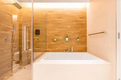 a bathroom with a large tub and a shower at Posh 2 BR Oceanfront Apt in the Heart of Bluewaters Island in Dubai