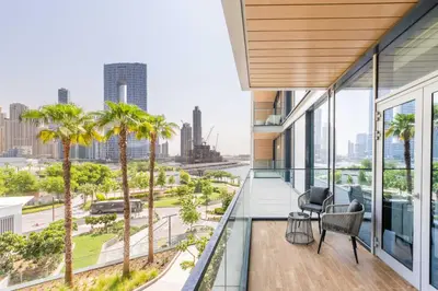 a balcony with palm trees and a view of the city at Island Paradise - Stylish 1BR on Bluewaters Island in Dubai