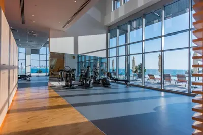 an office with a gym with a view of the ocean at Lavish & Equipped oceanfront 2 BR facing Ain Dubai in Dubai