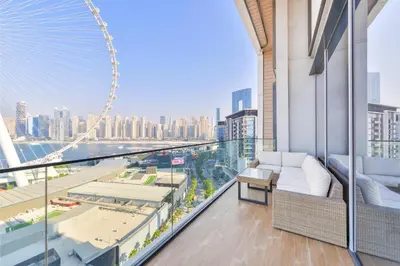 a view of the london eye from the balcony of a building at Lavish & Equipped oceanfront 2 BR facing Ain Dubai in Dubai