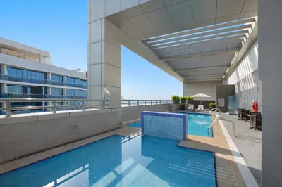 a swimming pool on the side of a building at Royal Continental Suites Business Bay - Deluxe Apartments in Dubai
