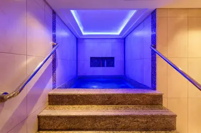 a walkway leading to a swimming pool in a bathroom at Royal Continental Suites Business Bay - Deluxe Apartments in Dubai