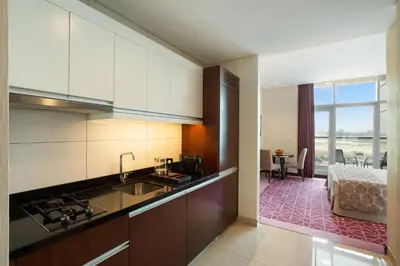 a kitchen with a sink and a counter top at Royal Continental Suites Business Bay - Deluxe Apartments in Dubai
